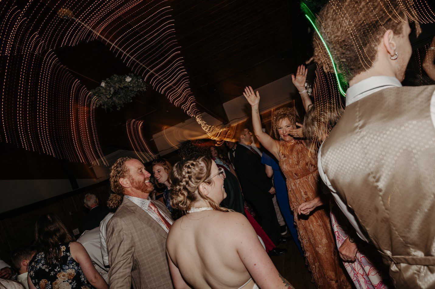 Wedding guests celebrating together on the dance floor at Lost Valley in Auburn, Maine
