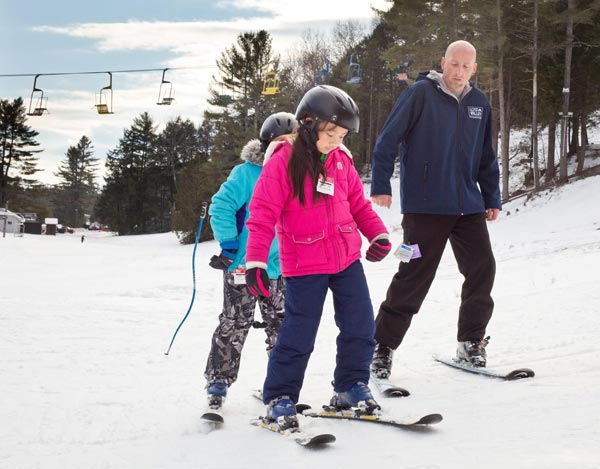child learning to ski